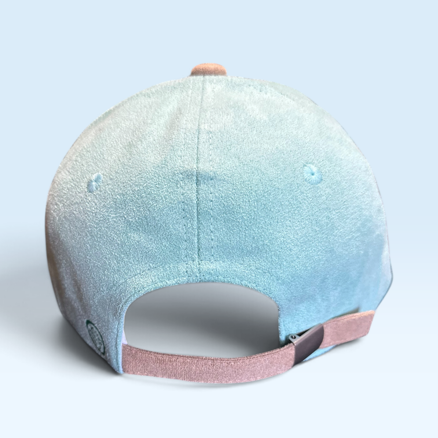 Back view of green vegan suede cap with tan adjustable strap buckle closure.
