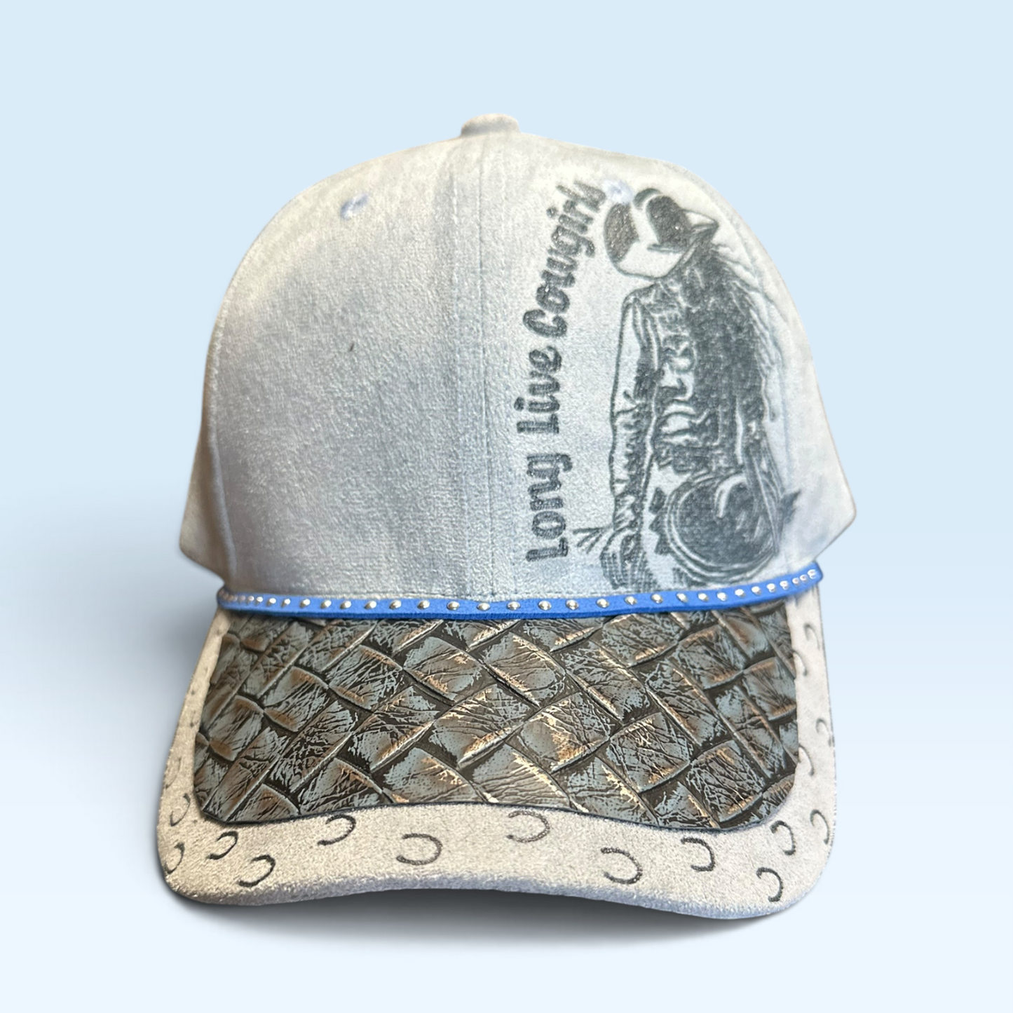 A light gray faux suede cap with burned graphic of a cowgirl with the text 'Long Live Cowboy' on the side.