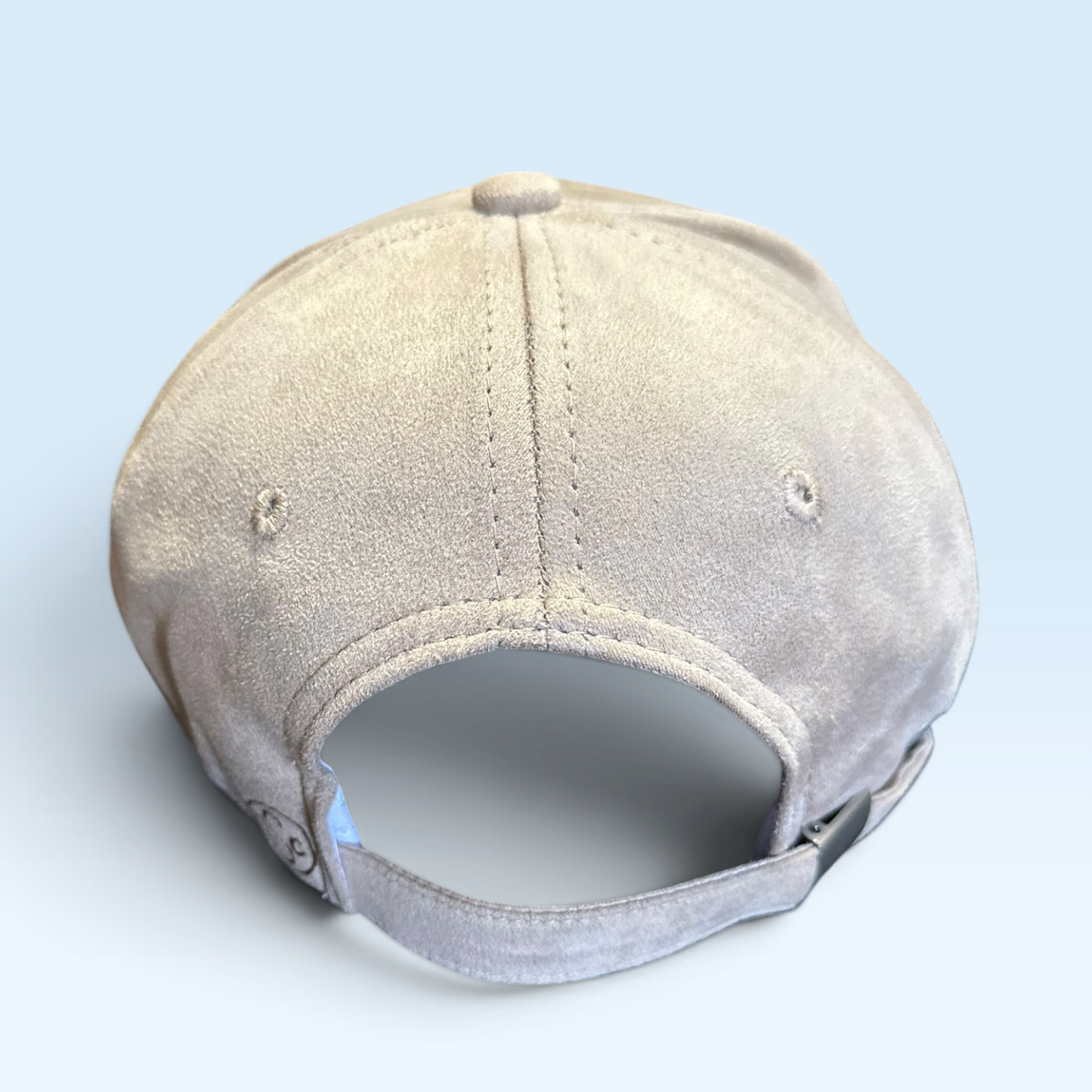 Back view of beige/tan cap with adjustable strap with metal buckle
