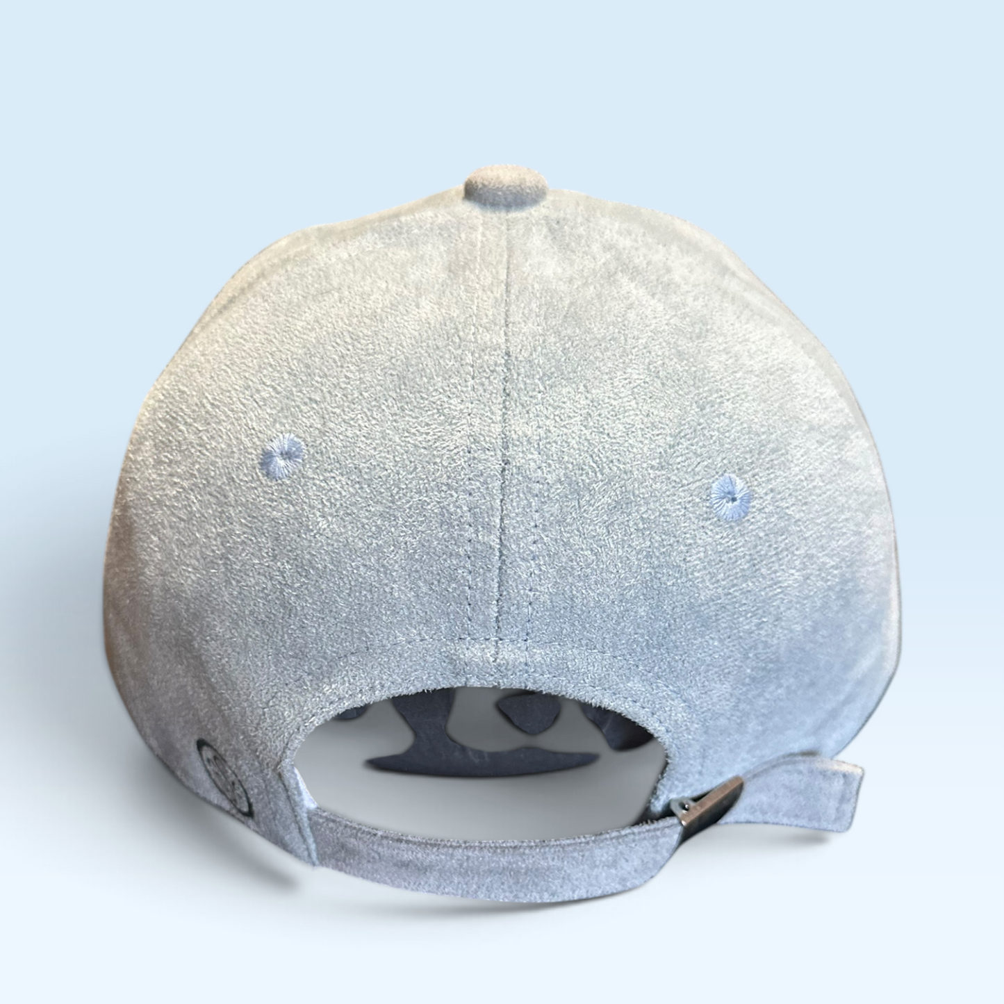 Back view of cap with strap and metal buckle closure
