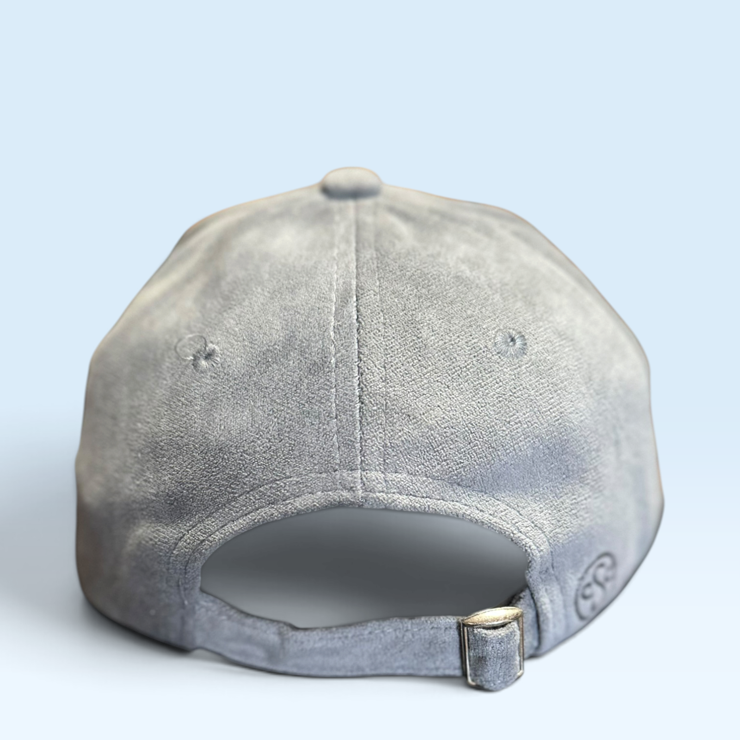 Back view of a light gray vegan suede cap with strap closure